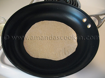 A close up photo of a low fat homemade tortilla being cooked in a skillet.