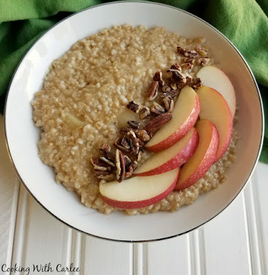 Loaded with apple flavor and that hearty steel cut oatmeal chew, this apple pie oatmeal is sure to be a favorite fall breakfast. Grab a spoon and dig in! bowl of apple steel cut oatmeal with apple slices and pecans