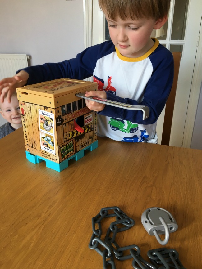 Crate-Creatures-Surprise-Blizz-Review-boy-using-crowbar-to-open-crate