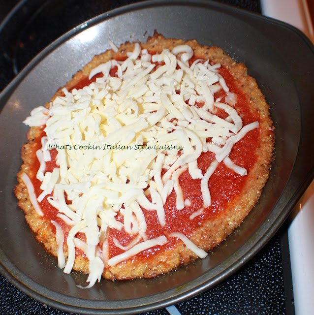 this is how to make a zucchini pizza crust into a real great tasting pizza. This is in a pie plate that is greased and sauce is on top with melted mozzarella cheese