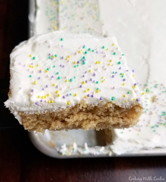 This easy and peanut buttery cake is perfect for feeding a crowd. It is made much like a Texas sheet cake and would be good with that chocolate icing, but we love it with white chocolate buttercream for an extra special treat!