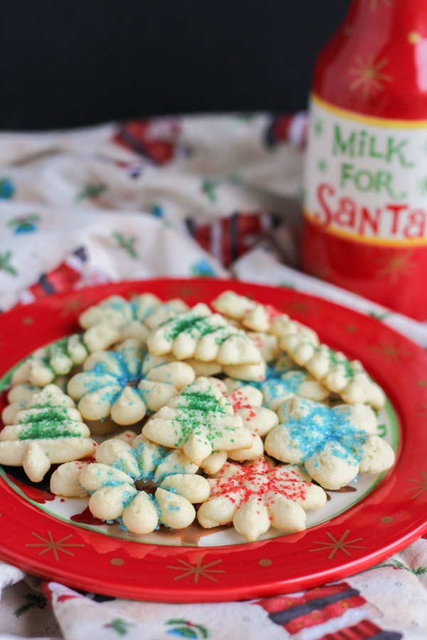 These Spritz Cookies are crisp and buttery and have a rich vanilla flavor. Just a few simple ingredients and a cookie press are all you need to make these Christmas classics!