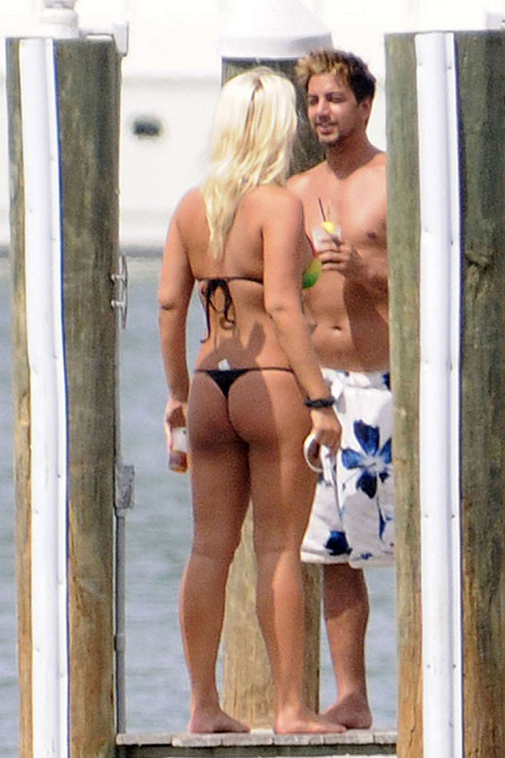 Brooke Hogan walking with most her ass on display in a thong bikini.