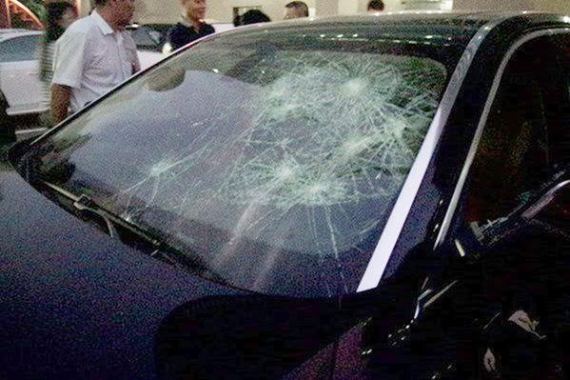 Photos: Wife destroys cheating husband's luxury car with a hammer