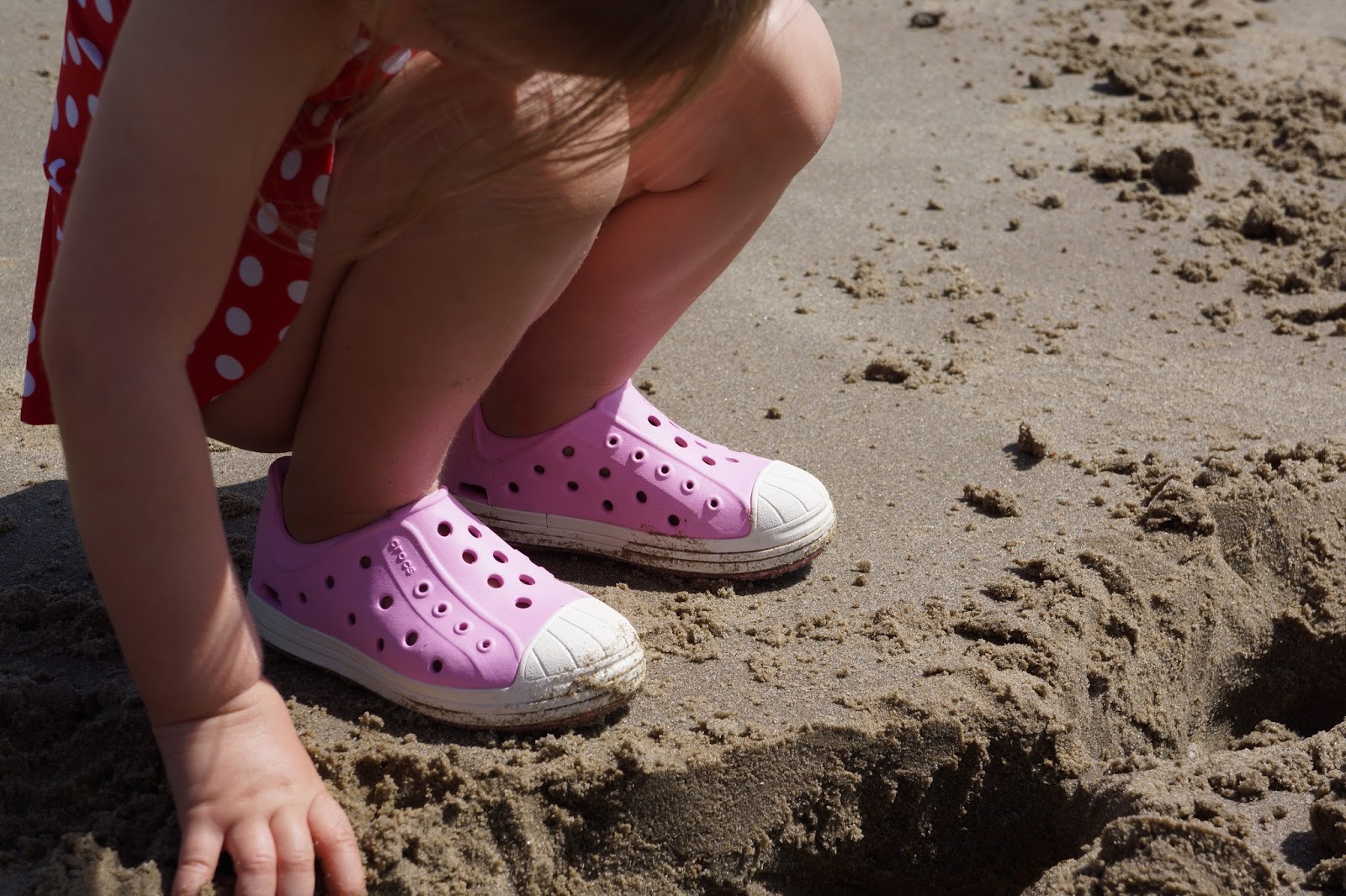 pair of light pink crocs beach shoes