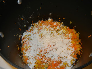 onion, corn, bell pepper, carrots in a large pot with flour sprinkled over them 