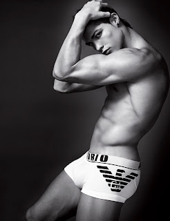 A black and white shot of a male model wearing Armani underwear
