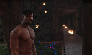 It's a picture of Killmonger, in a garden, shirtless.
