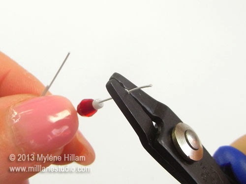 Using the crimping pliers to crimp the #1 crimp tube close to the end of a beading wire