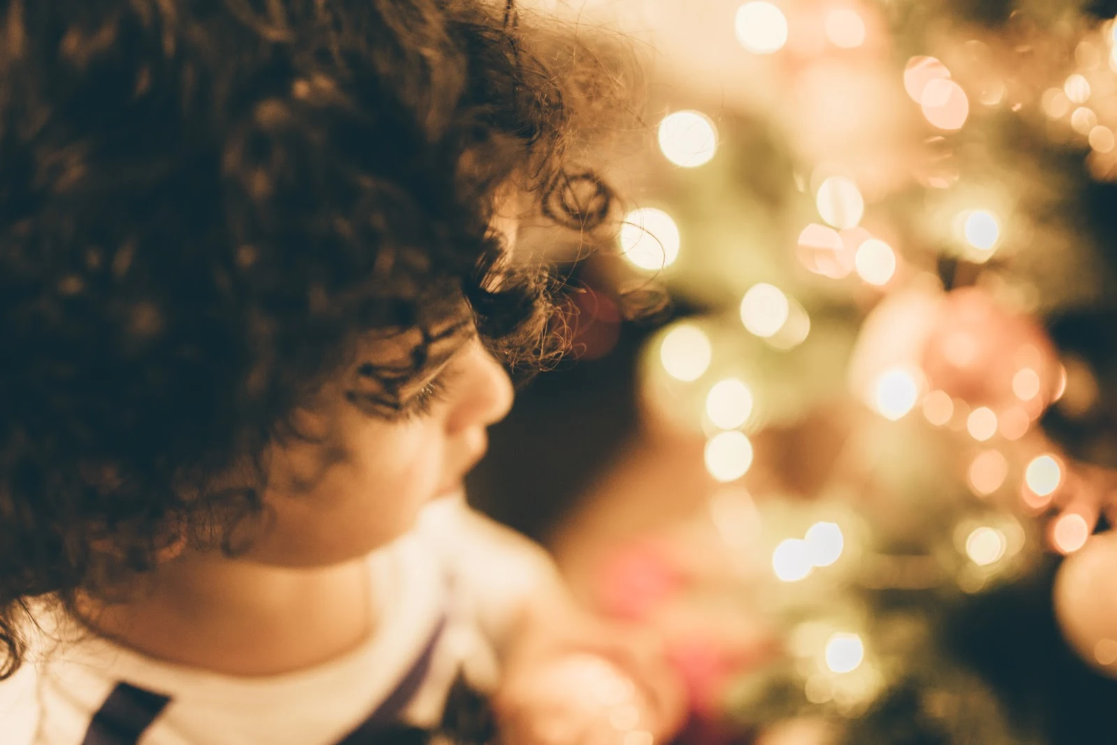 クリスマスの明るい飾り付けの部屋に立つ子供
