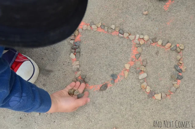 Tracing chalk letters with small rocks