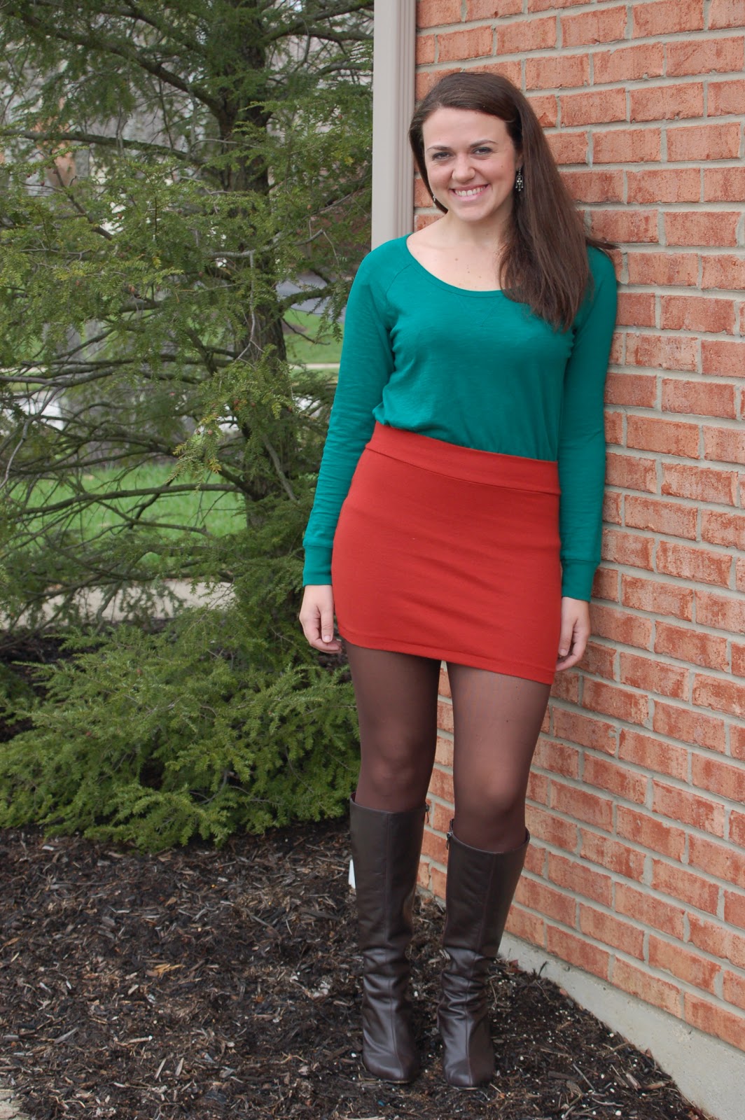 A plain, green long sleeved top with a fun orange-red mini skirt. 