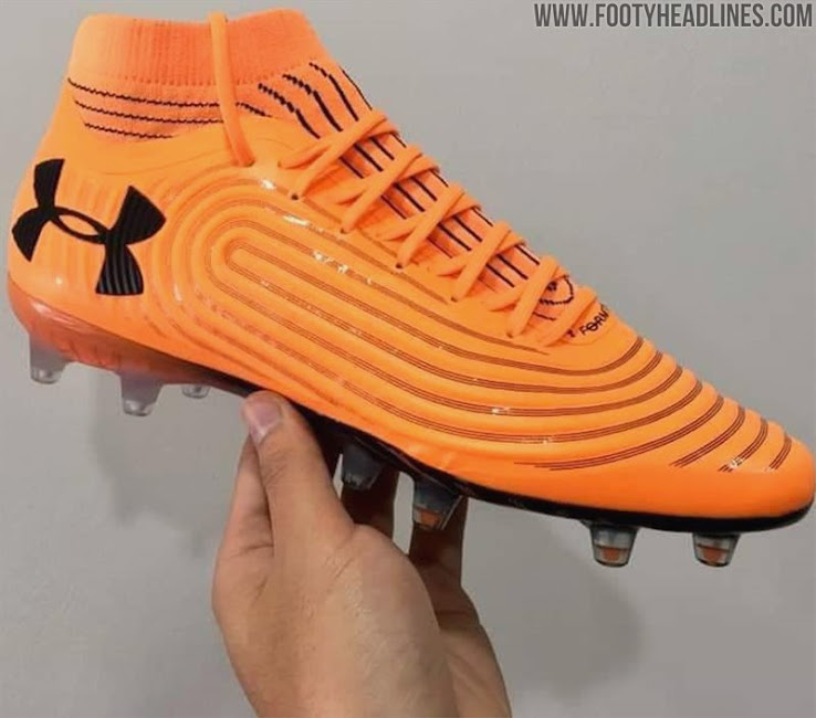 orange and black under armour football cleats