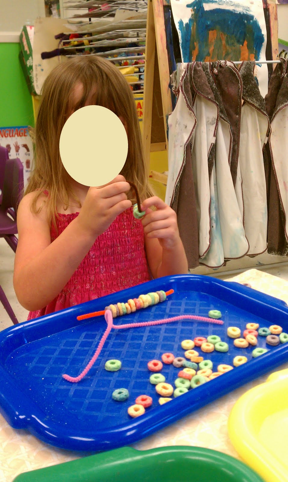 View of Play-Based Classroom: Lacing with cereal