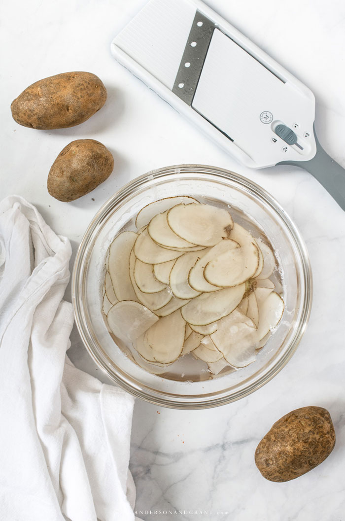 Bowl of potato slices resting in water