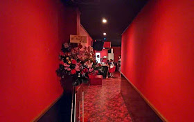 red walls, red floor, hallway, bar,flowers