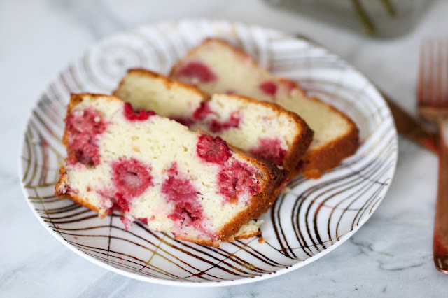 Raspberry lemon loaf on pretty gold and white plate with copper utensil