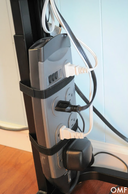 Using the velcro roll, you can cut them to length and organize your power strip and cords :: OrganizingMadeFun.com