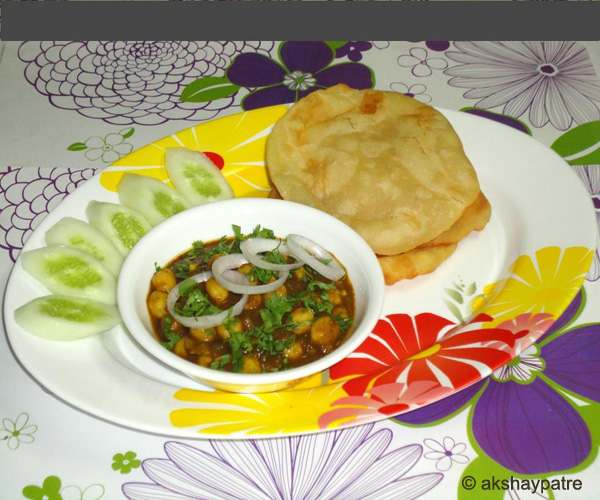 palak chole bhature in a serving plate
