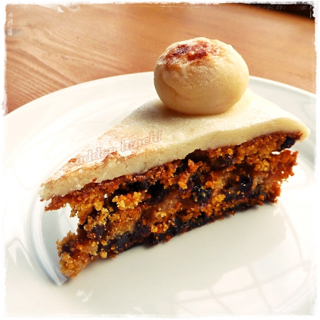 slice of homemade simnel cake with marzipan ball