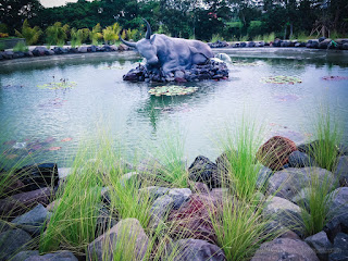 Sweet View Of The Pond With Sleeping Bull Statue In The Middle In The Park At Badung, Bali, Indonesia