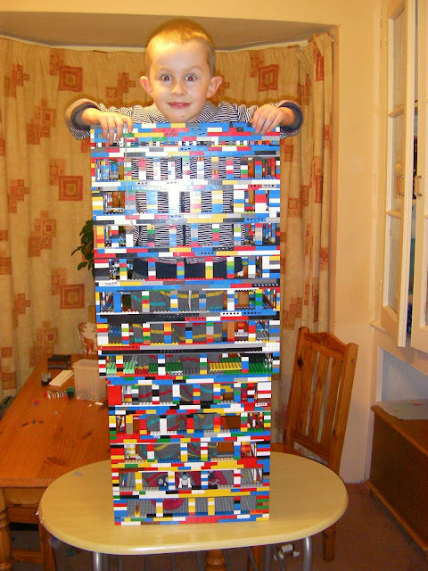 giant lego building with a boy in it