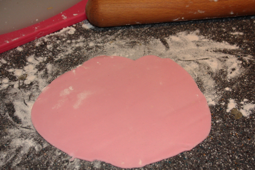 pink fondant rolled out on a flat surface