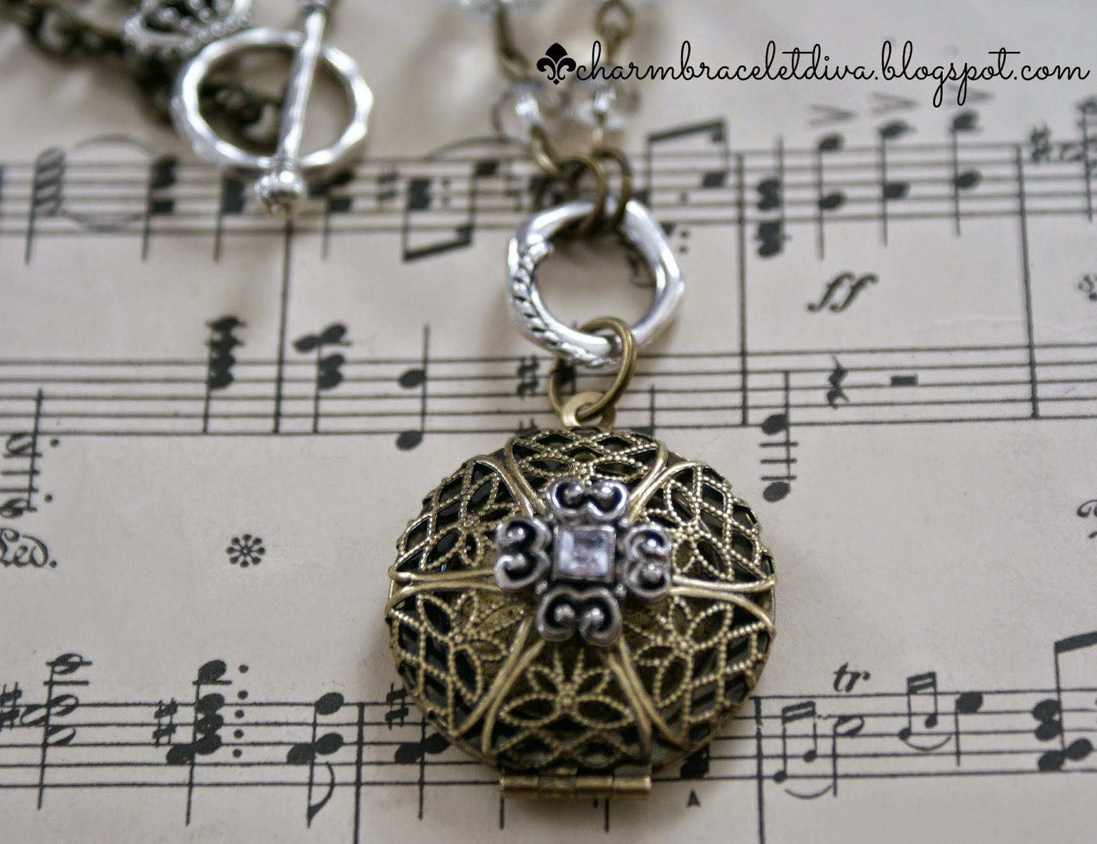 filigree antique brass locket with repurposed charm and faceted beads