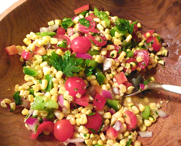 Leftover Dressed Salad Mixed in Large Wooden Salad Bowl