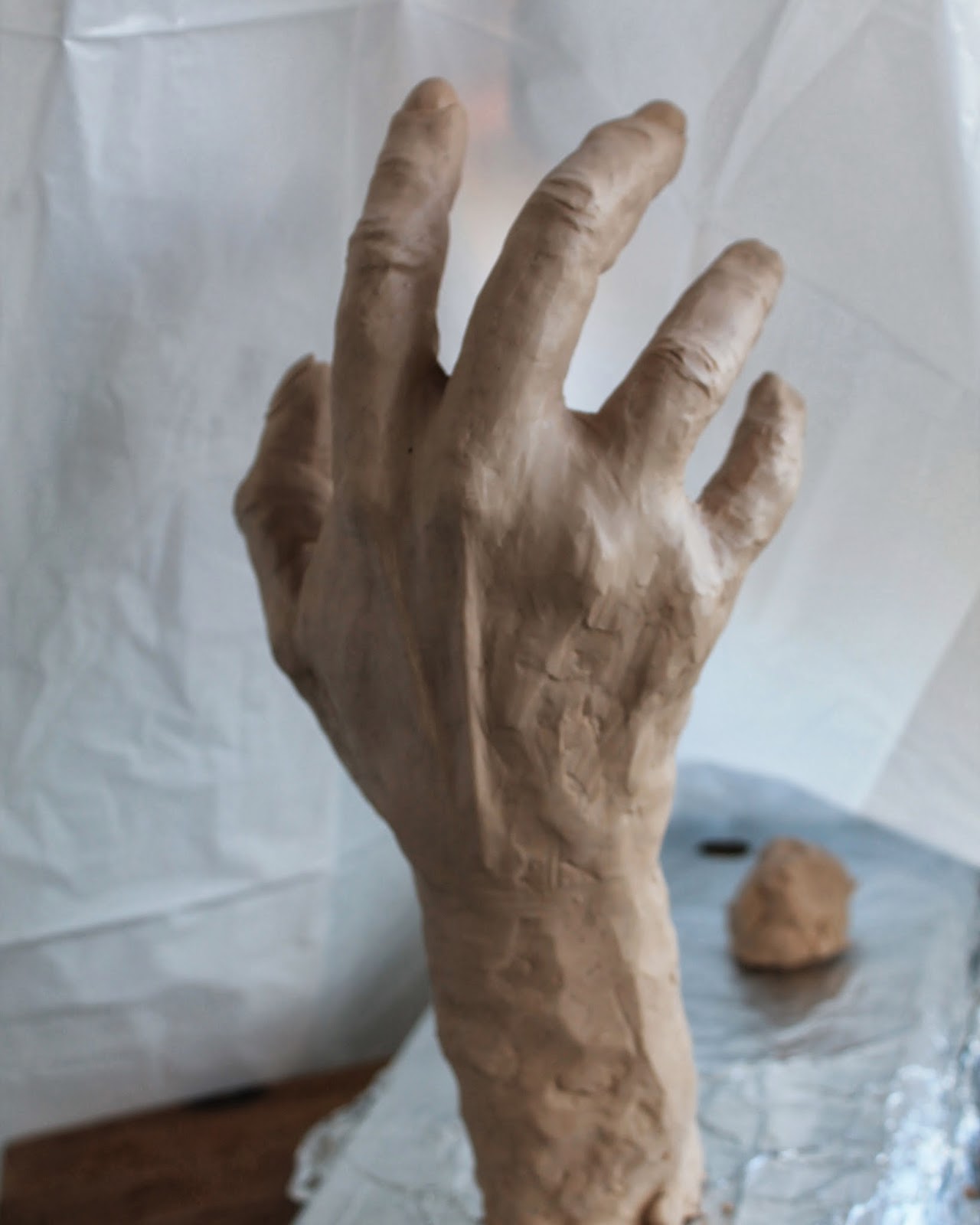 Connecting Pieces Sculpting a Hand out of Sculpy Clay The Wine Grab Sign