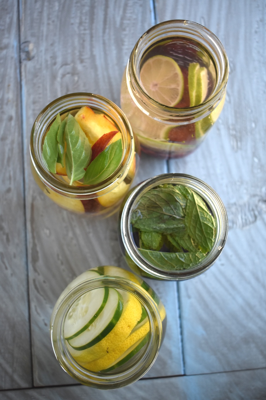 Infused water in 4 different flavors for a super refreshing, no-sugar added drink- lemon cucumber, peach basil, blueberry mint and cherry lime! www.nutritionistreviews.com