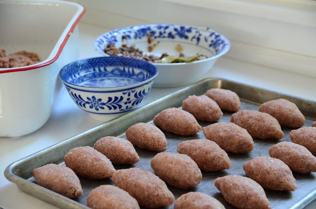 Raw kibbeh balls with bowls