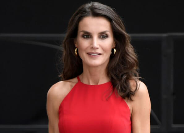 Queen Letizia wore a halter neckline red dress by Carolina Herrera, and nude patent leather slingback pumps, and animal print clutch