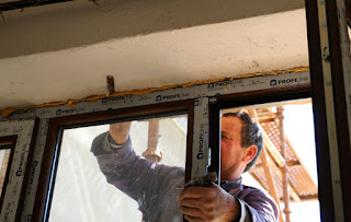 Bekir using a saw to remove the window Bekir using a saw to remove the window
