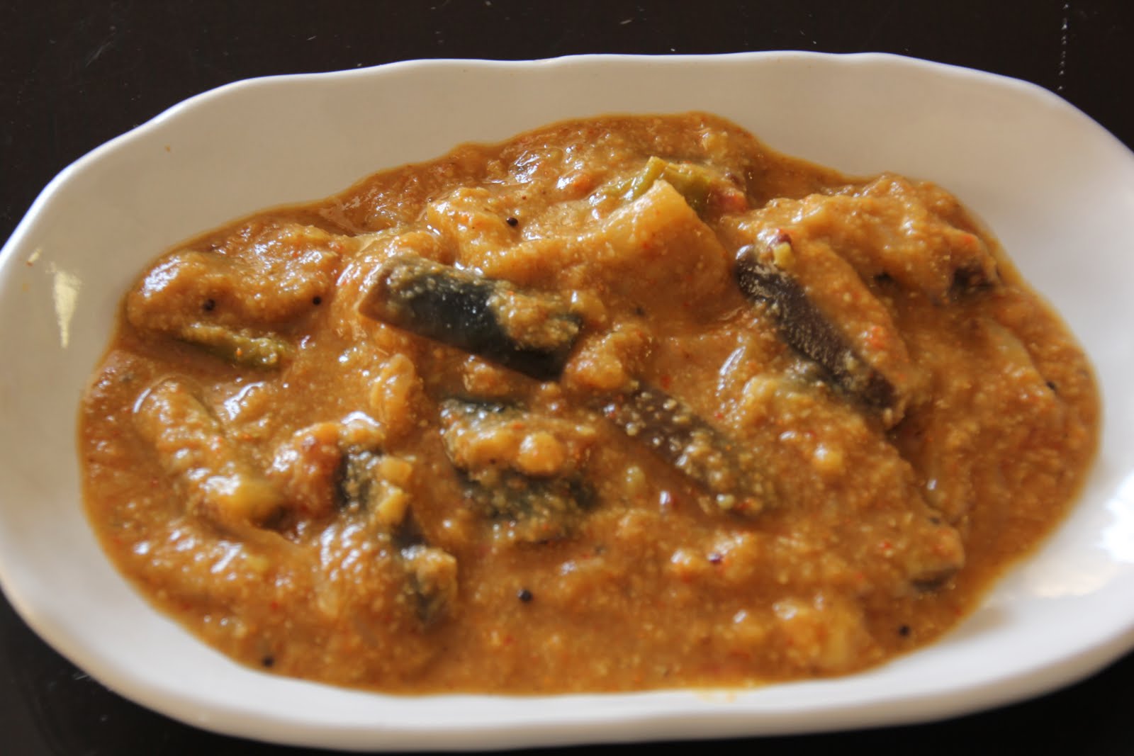 Try me from Recipe Basket....... Brinjal Curry/brinjal kulambu