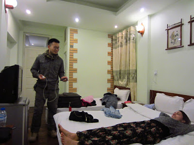 Two hostel guests relax in a hostel in Hanoi, Vietnam