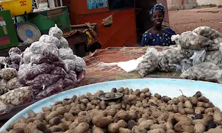 Selling nuts at an African market by qtea