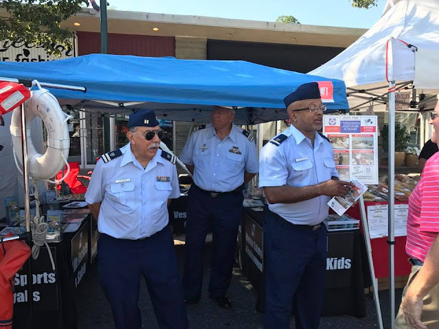 Three Auxiliarists are waiting to answer questions.