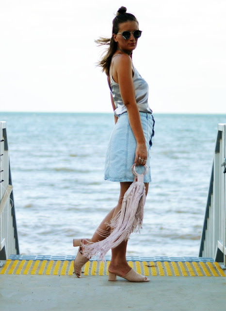 style a silk cami with a denim skirt and statement fringe bag style a silk cami with a denim skirt and statement fringe bag