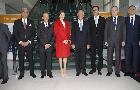 Queen Letizia wore Zara wool coat in red, Carolina Herrera Floral Dress and Lodi Saray Pumps at European Conference in Porto