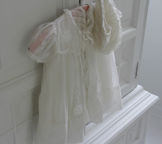 Vintage Christening gown on white armoire by Hello Lovely Studio