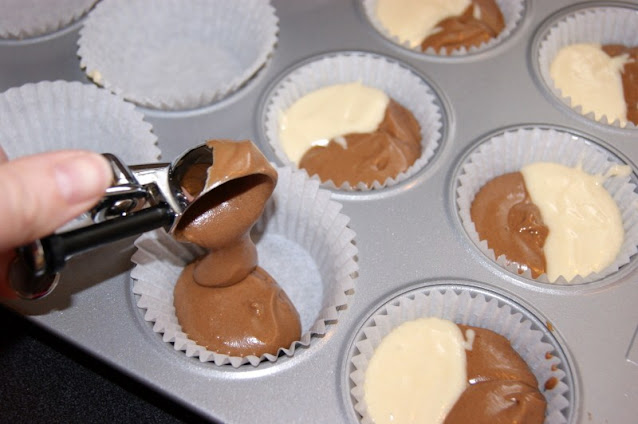 Adding Chocolate Batter to Make Neapolitan Cupcakes Image