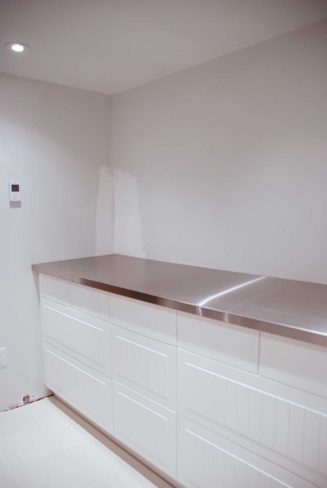 stainless steel countertop in laundry room, floating countertop in laundry room
