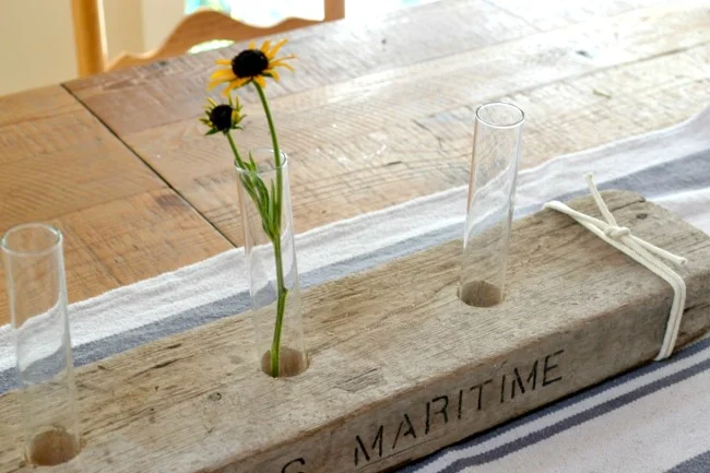 test tubes and flowers in driftwood centerpiece