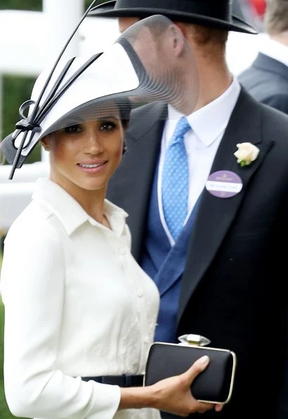 Duchess Meghan Markle wore a bespoke white shirt-style dress by Givenchy and carried a black handbag by the same brand Givenchy