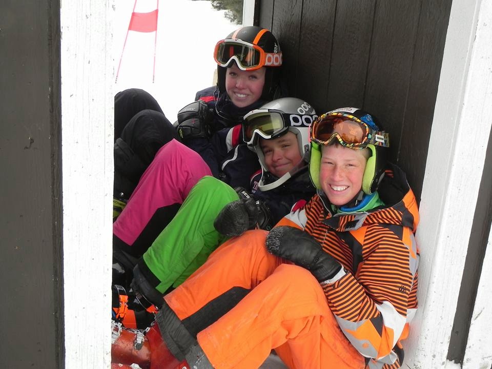 Three skiers sitting