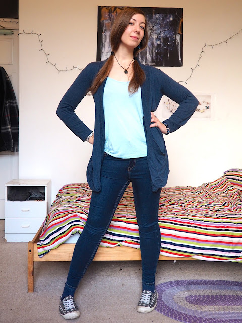 Stitch Disneybound inspired outfit of light blue top, with dark blue cardigan and skinny jeans