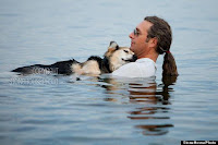 Tender: John Unger gently cradles Schoep in the warm waters of Lake Superior