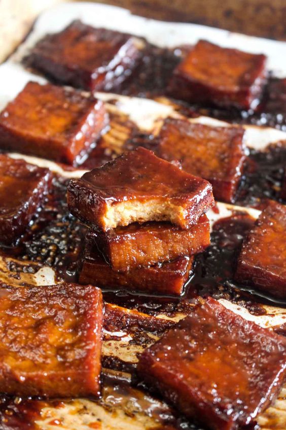 This 6 ingredient Best Ever Baked Tofu is jam packed with savory & sweet flavor! Learn how to make even tofu haters into lovers with this recipe. | CatchingSeeds.com