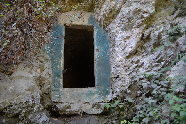 green painted cement opening in the rock